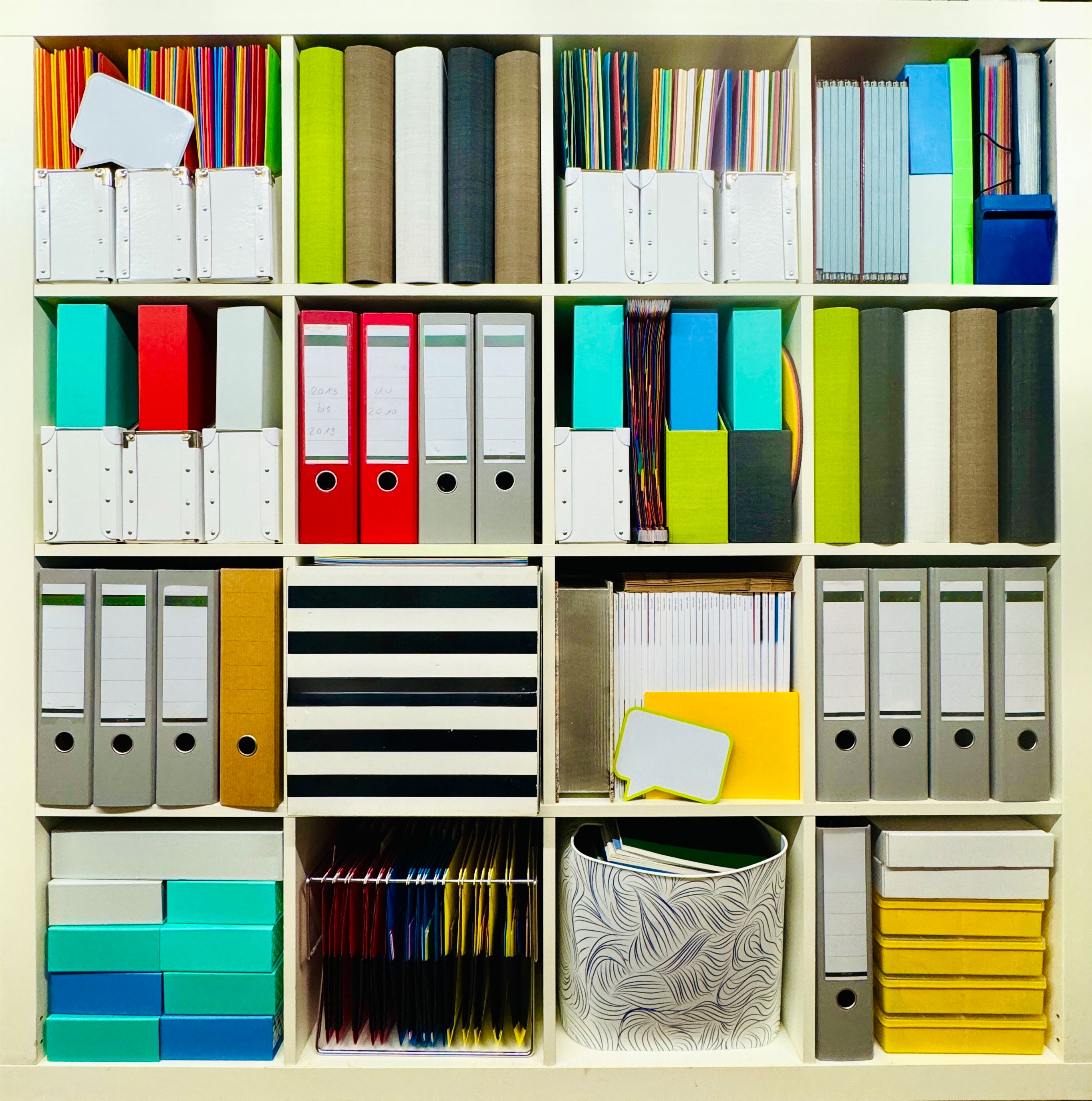 shelves of papers and files in an office, neatly organized