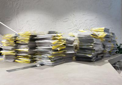 piles of papers inside messy folders on a desk