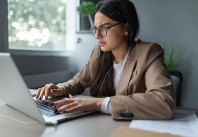 Young professional woman at work frustrated with what is on her laptop