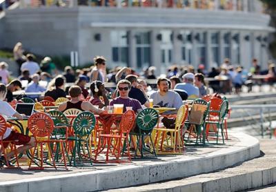people sitting at tables outside of the Wisconsin Union 
