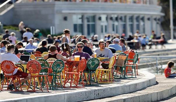 people sitting at tables outside of the Wisconsin Union 