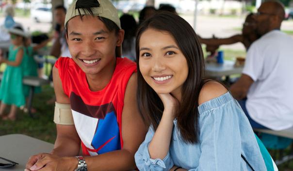 young adult asian american couple at an outdoor picnic