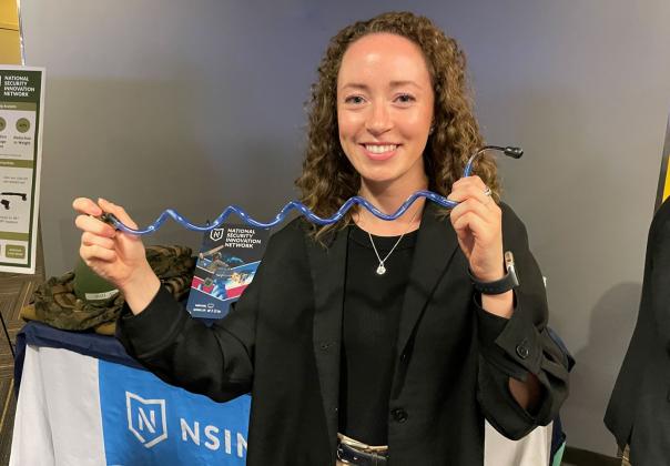 medical student displaying work at conference