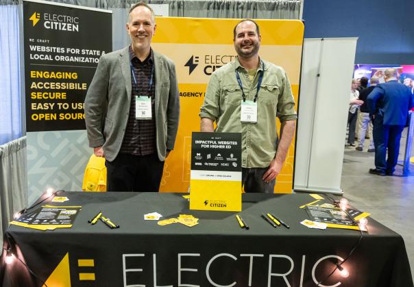 Electric Citizen's team members working at a conference booth