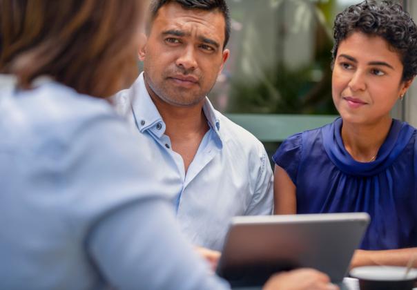 concerned adult couple listening to an advisor