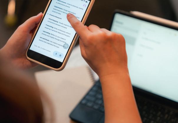 close up of person's hands as they browse search results on their mobile device