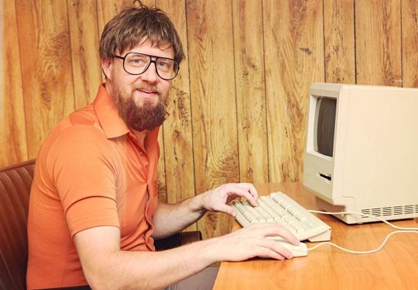 1980s style office worker with old computer