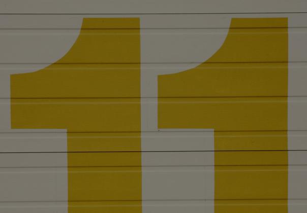 large gold colored number 11 painted on a wall