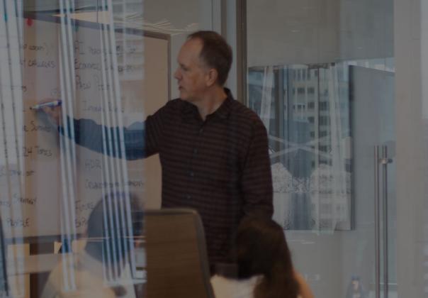 photo of man leading a group discussion in a conference room