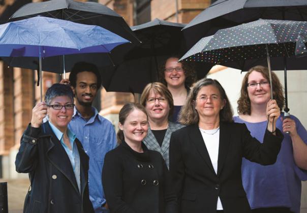 staff of legal state support, outside with umbrellas in their hands