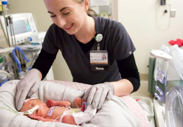 nurse caring for a newborn baby in hospital