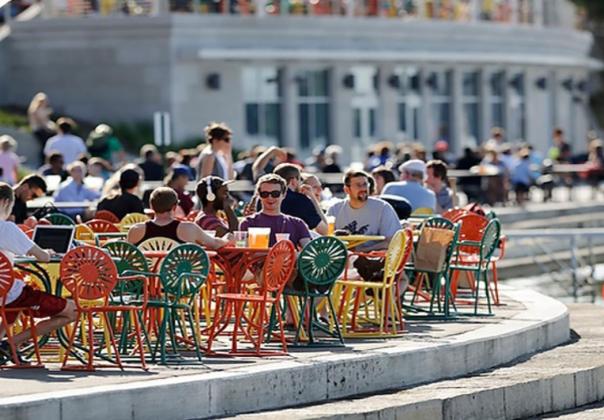 people sitting at tables outside of the Wisconsin Union 