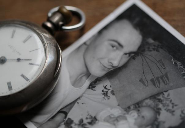 Pocket watch and old photograph of mother and child
