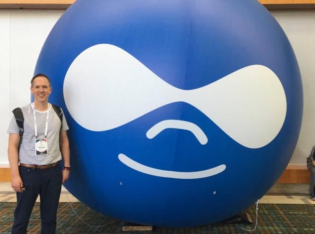 Electric Citizen team in front of inflatable Drupal icon
