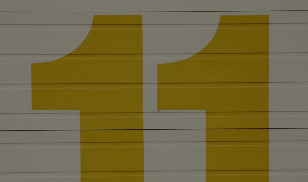 large gold colored number 11 painted on a wall