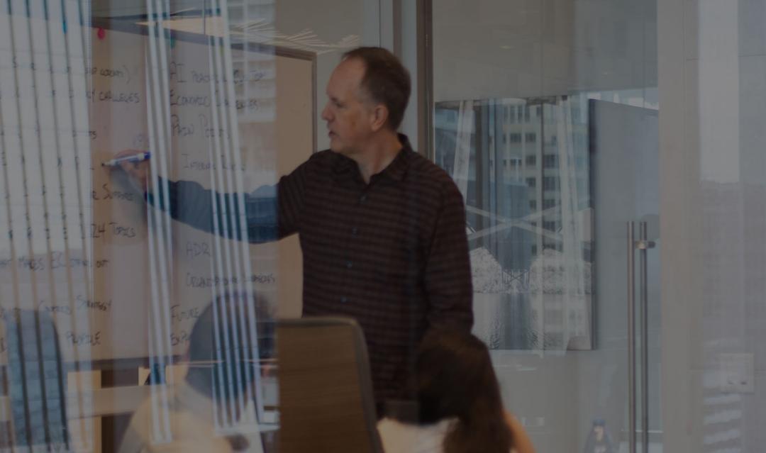 photo of man leading a group discussion in a conference room