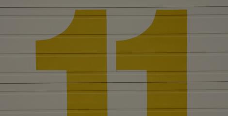 large gold colored number 11 painted on a wall