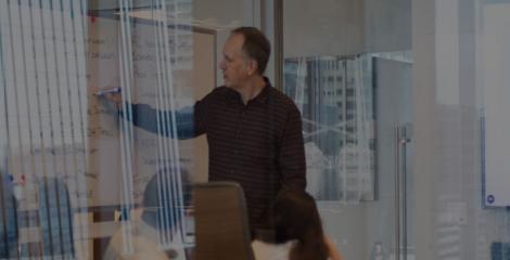 photo of man leading a group discussion in a conference room