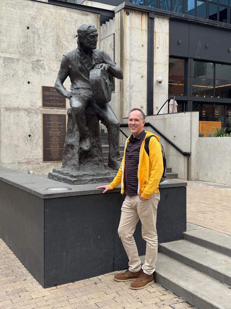 Dan posing in front the Willie Nelson statue in downtown Austin