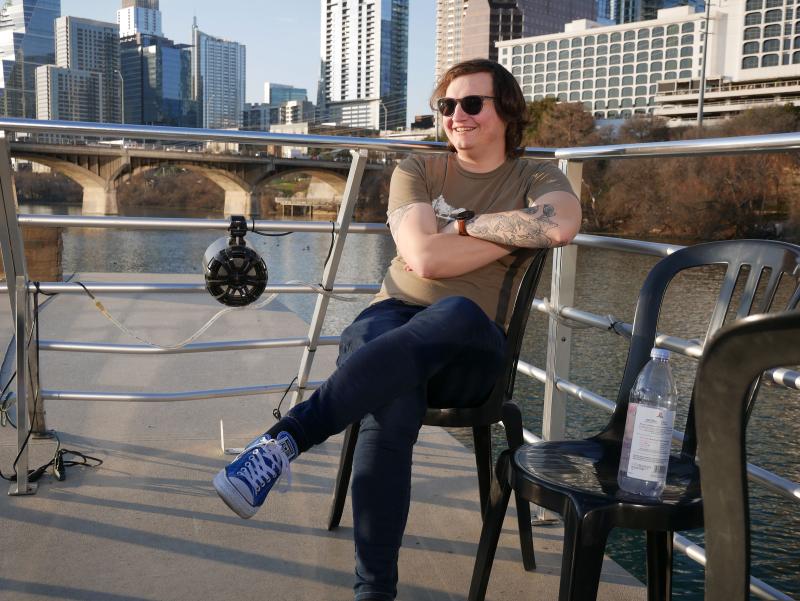 young adult relaxing outdoors on a boat deck