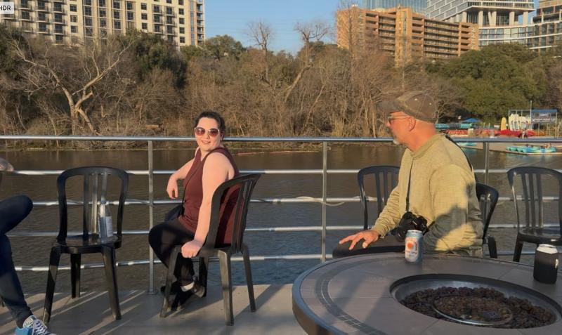 two members of our team, sitting in the sun on the deck of a boat