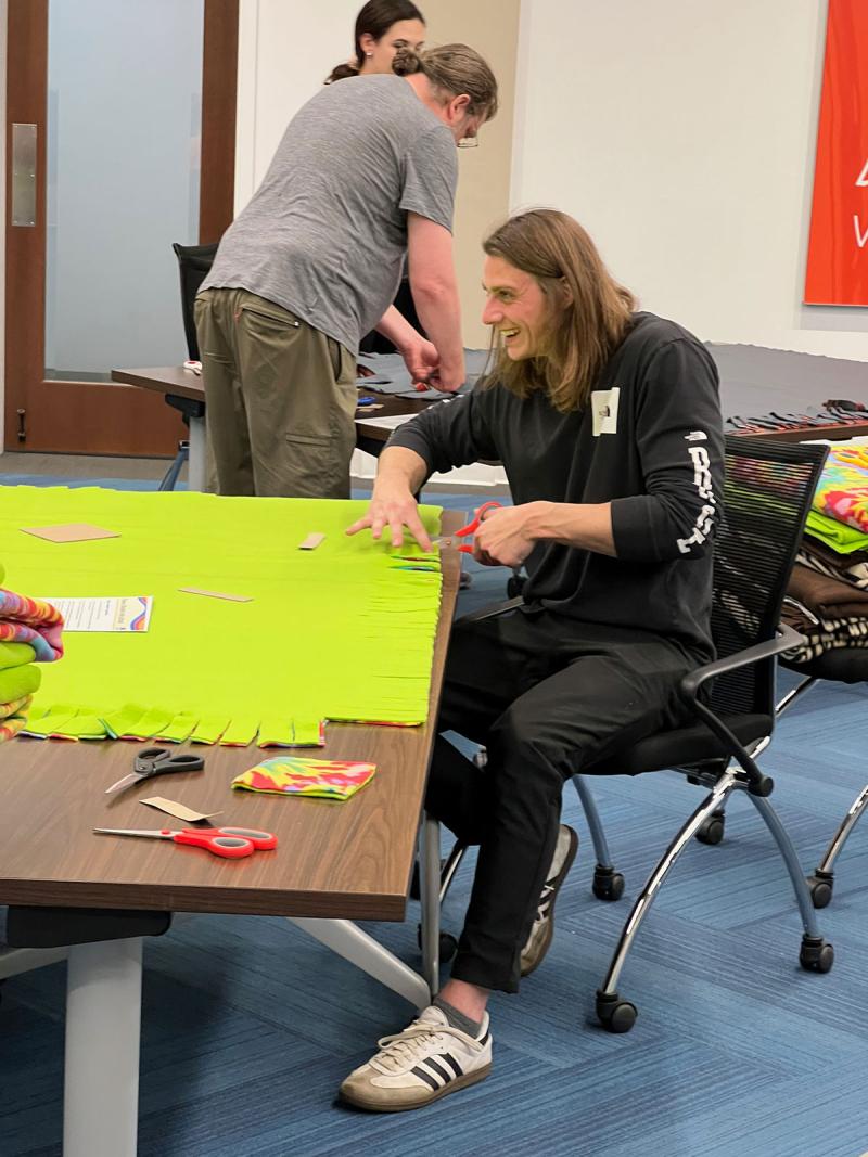 Trent cutting fabric at volunteer event