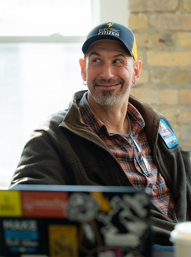 Wilbur and his laptop, wearing Electric Citizen hat