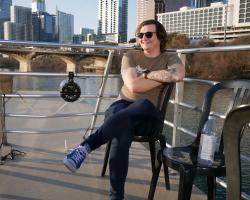 young adult relaxing outdoors on a boat deck