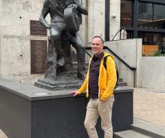 Dan posing in front the Willie Nelson statue in downtown Austin