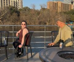 two members of our team, sitting in the sun on the deck of a boat