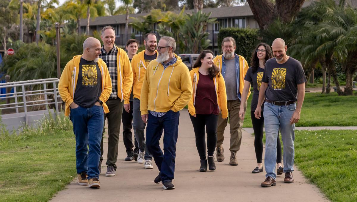 EC team members walking together outside along the grass