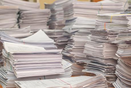 Pile of paper documents in an office setting