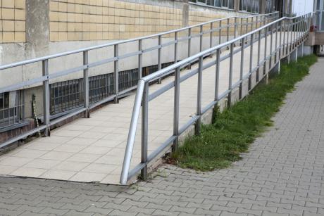 Building entrance with ramp for disabled person wheelchair