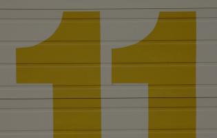 large gold colored number 11 painted on a wall