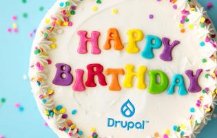 Birthday cake with "happy birthday" written on the top and a Drupal logo