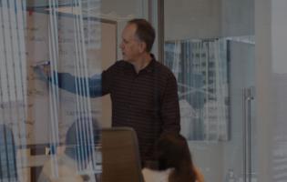 photo of man leading a group discussion in a conference room