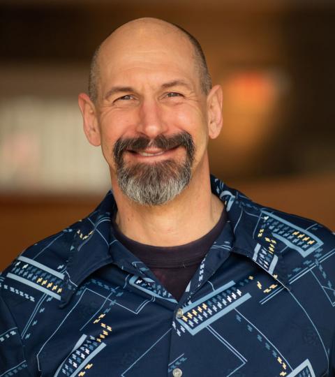 photo of Wilbur Ince wearing a printed dark blue shirt